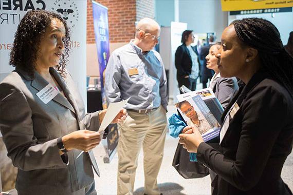 Student talking with recruiter at career fair